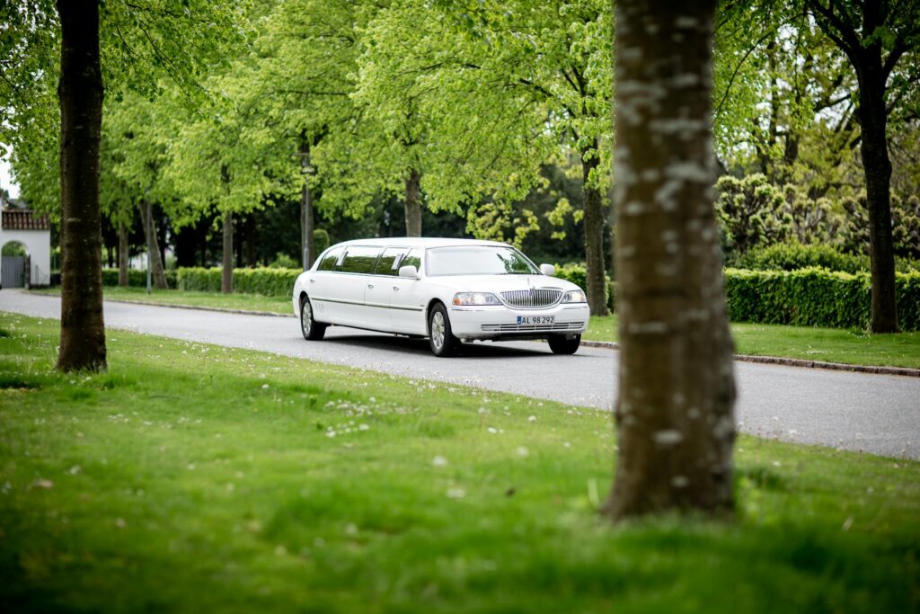 PGA National Resort car service: luxury white stretch limousine arriving at the premier PGA National Resort entrance.