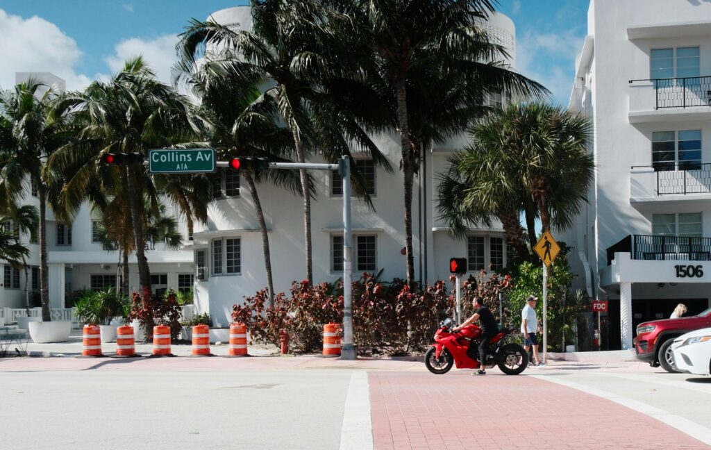 Worth Avenue Palm Beach luxury shopping destination - Motorcycle passing Collins Avenue in sunny Miami B